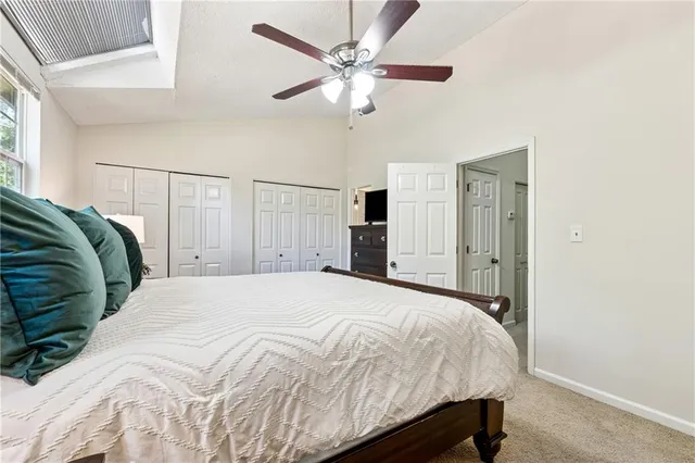 a bedroom with a bed and a ceiling fan