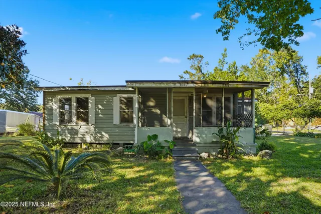a front view of a house with a garden