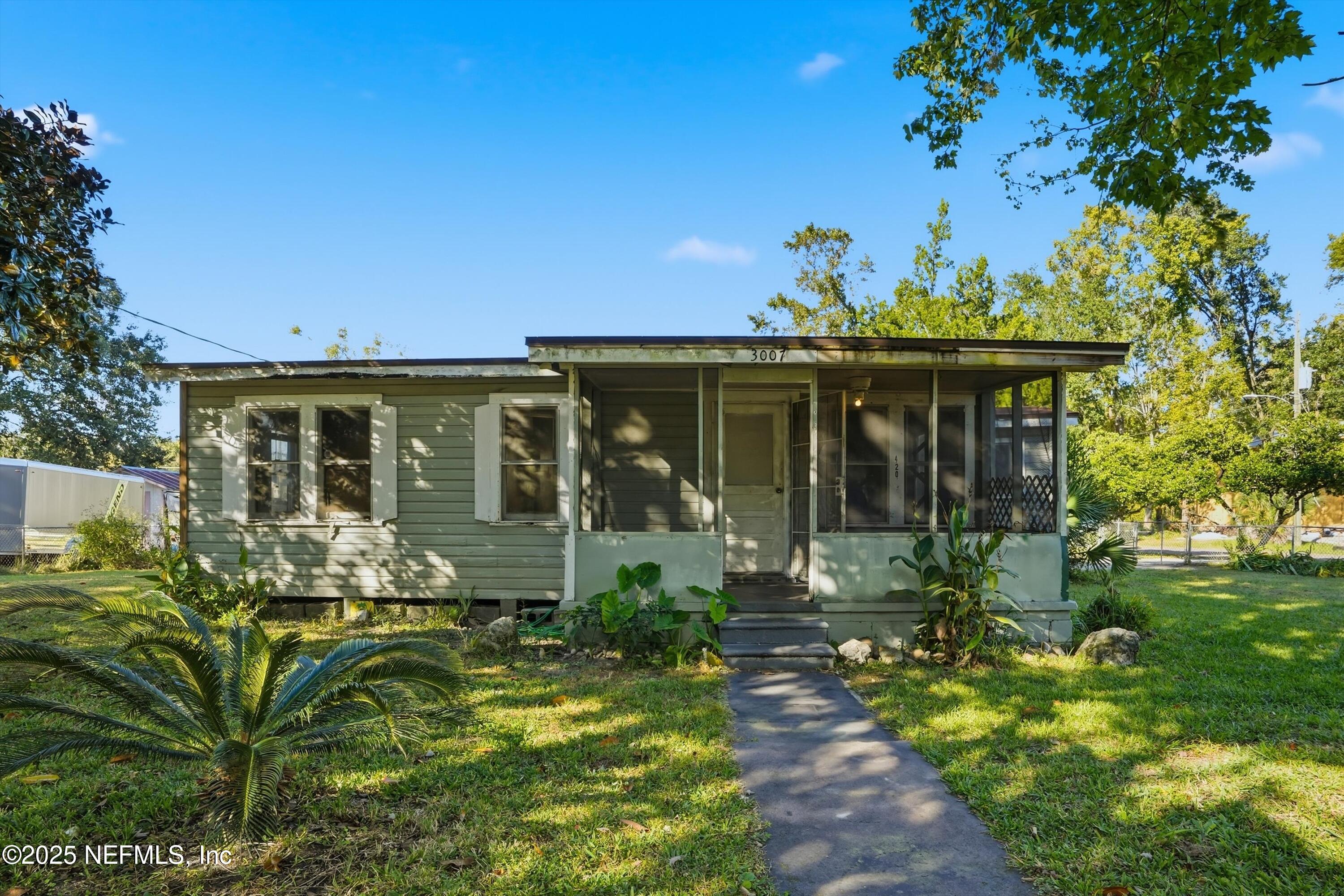 11558 Raft Road Jacksonville, FL 32218 - Photo 22 of 32 a front view of a house with a garden