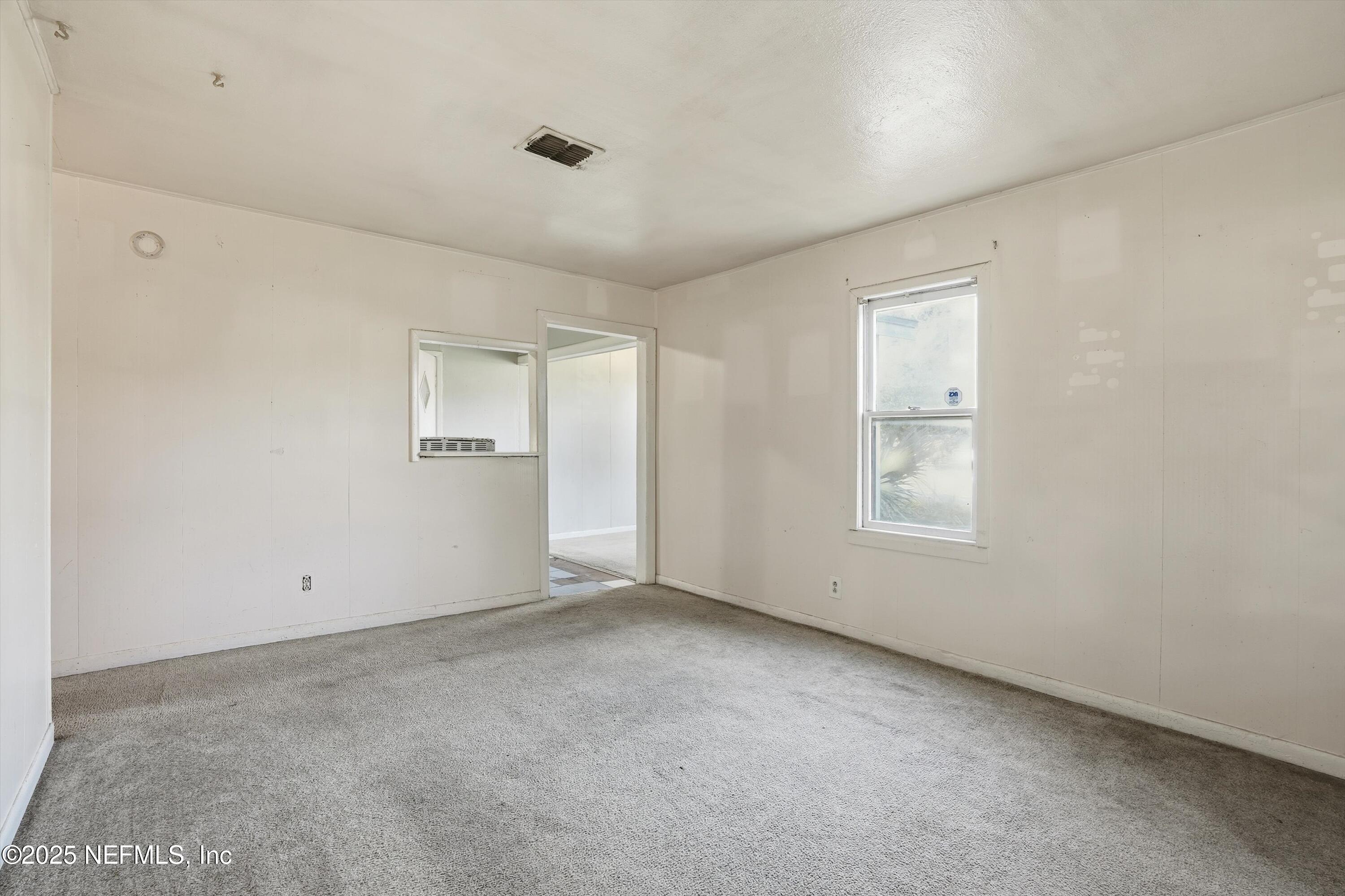 11558 Raft Road Jacksonville, FL 32218 - Photo 24 of 32 an empty room with windows