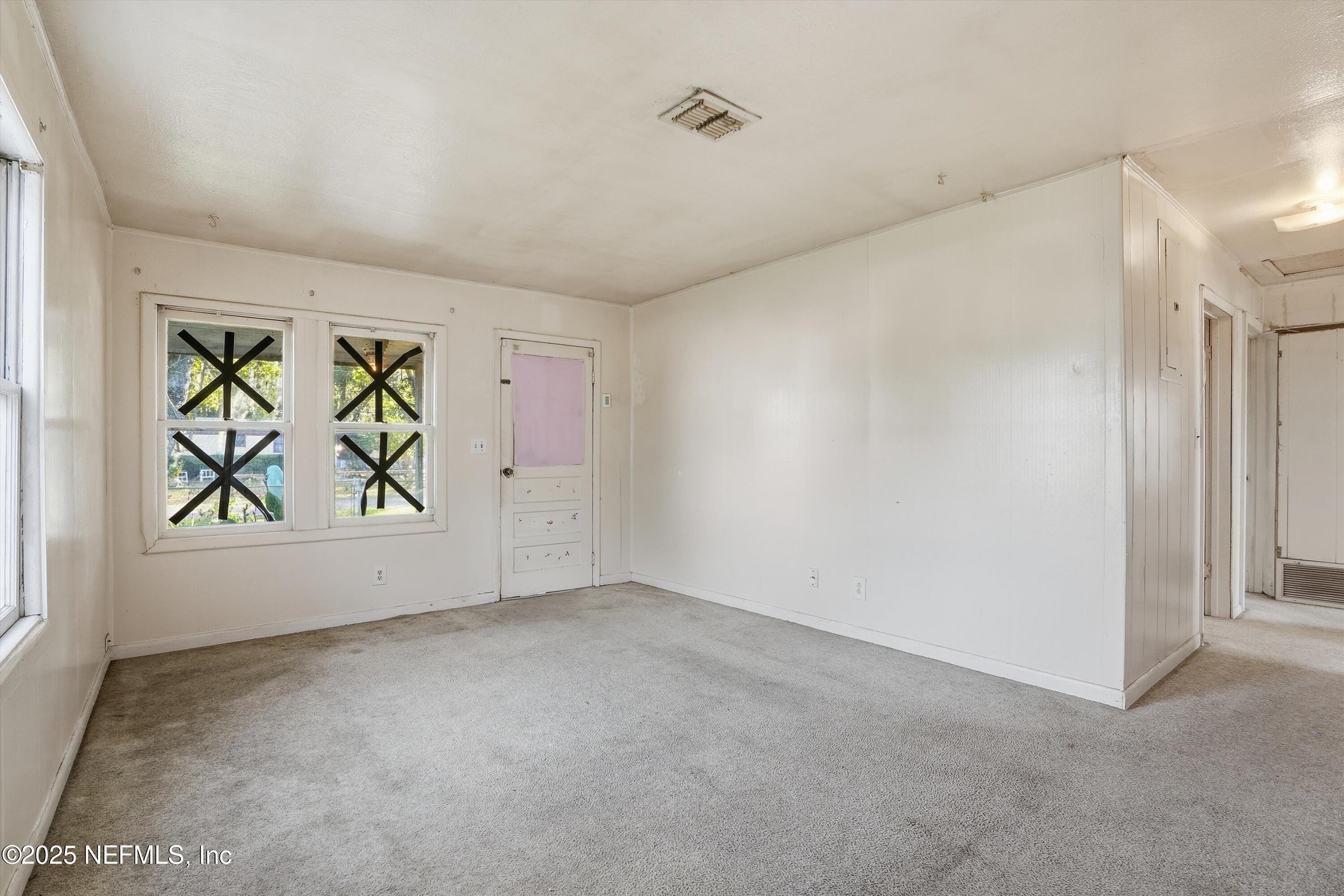 11558 Raft Road Jacksonville, FL 32218 - Photo 25 of 32 an empty room with window and wall painting