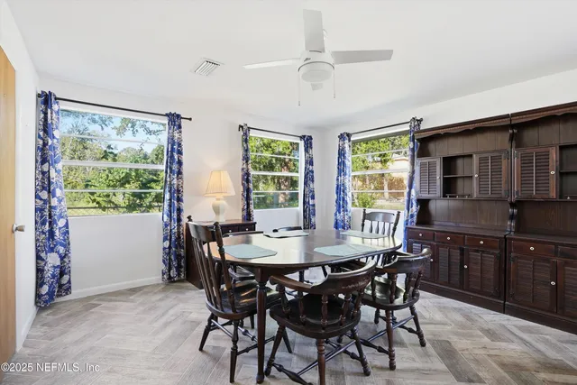 a view of a dining room with furniture window and outside view