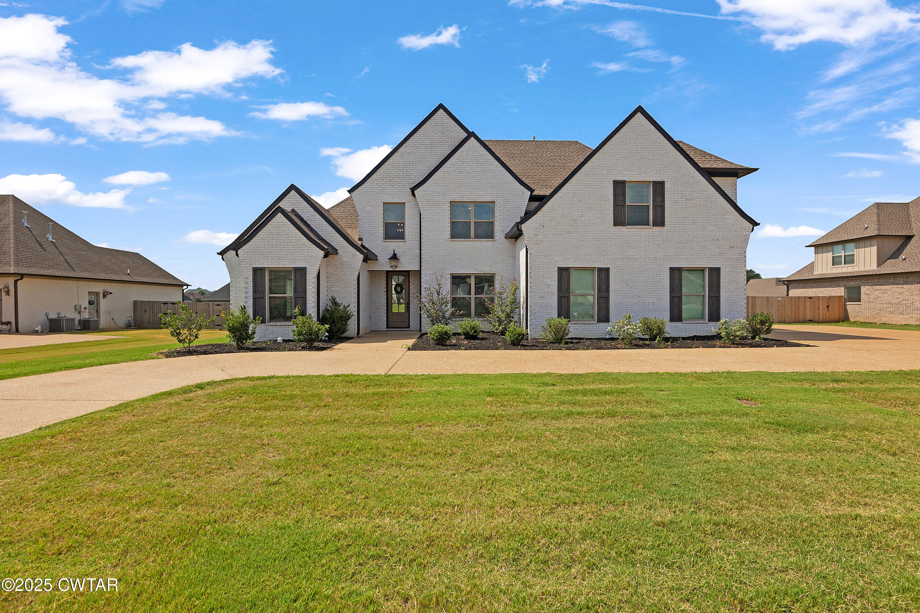 a front view of a house with a yard
