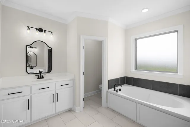 a bathroom with a bathtub sink and mirror