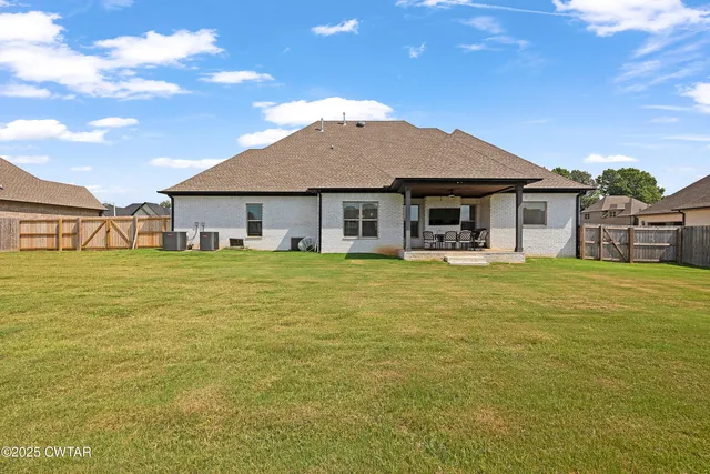a front view of house with yard and ocean view