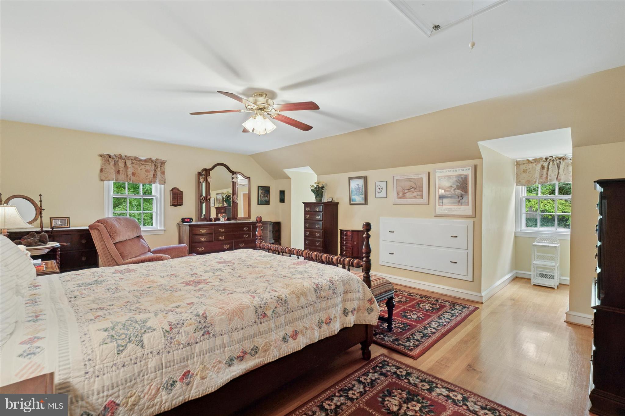 240 Rices Mill Road Wyncote, PA 19095 - Photo 22 of 36 a bedroom with a large bed a chandelier and dresser