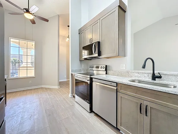 an empty room with a window and a fan