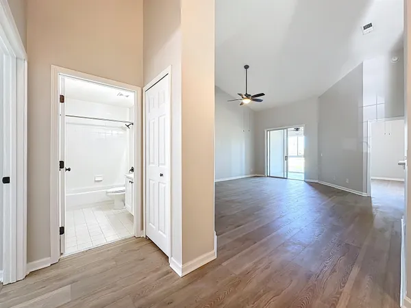 a view of an empty room with wooden floor