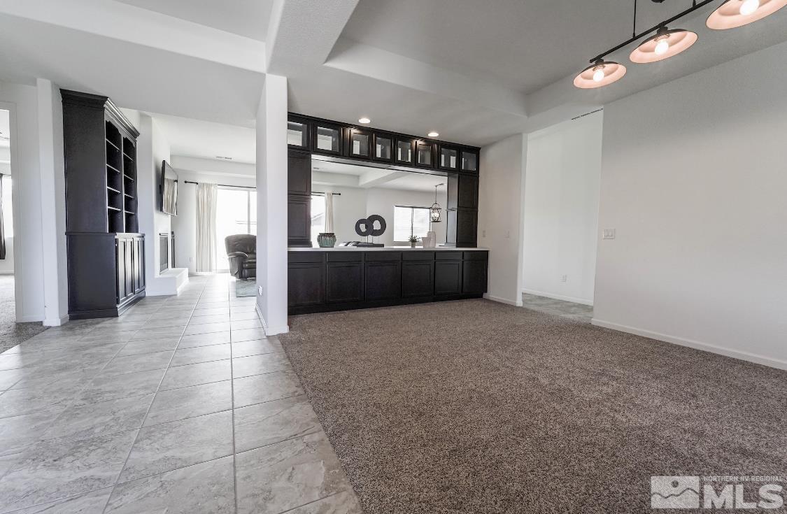 10080 Ellis Park Lane Reno, NV 89521 - Photo 5 of 26 a view of a hallway with wooden floor and a large mirror