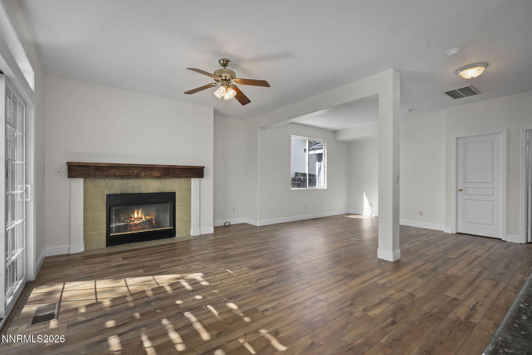 5490 Twin Creeks Drive Reno, NV 89523 - Photo 12 of 27 a view of an empty room with a fireplace and a window