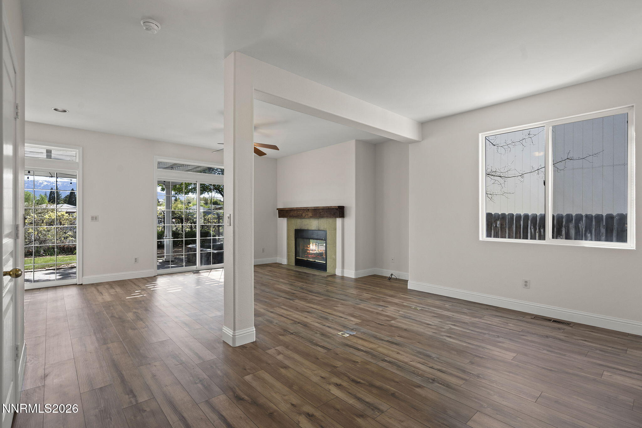 5490 Twin Creeks Drive Reno, NV 89523 - Photo 13 of 27 wooden floor fireplace and windows in an empty room