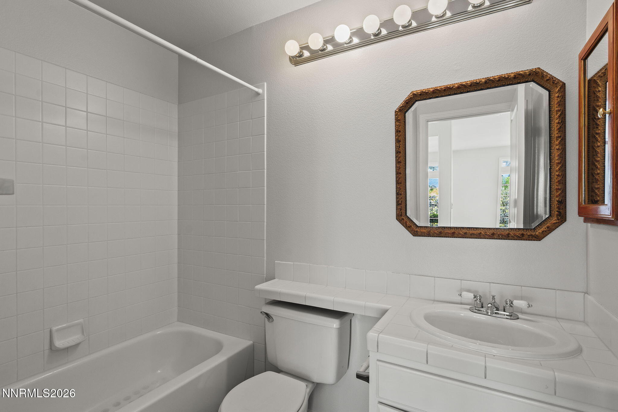 5490 Twin Creeks Drive Reno, NV 89523 - Photo 22 of 27 a bathroom with a toilet sink and mirror