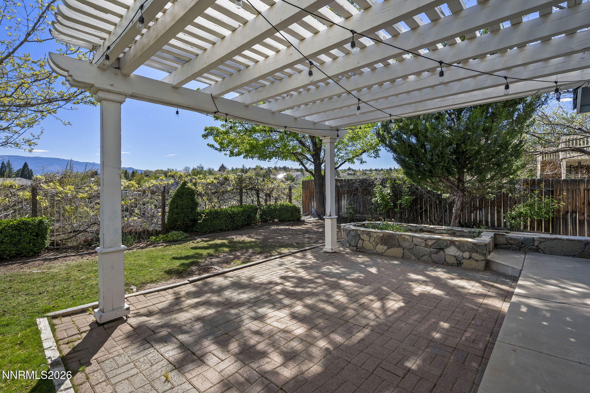 5490 Twin Creeks Drive Reno, NV 89523 - Photo 25 of 27 a view of a backyard with a big tree and a yard