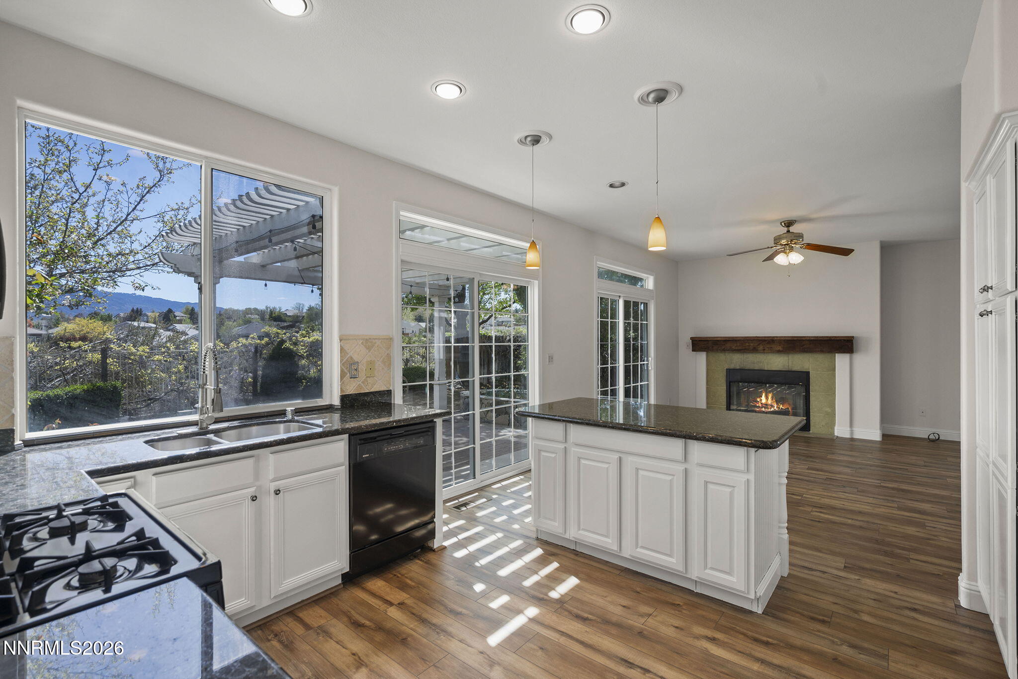 5490 Twin Creeks Drive Reno, NV 89523 - Photo 6 of 27 a kitchen with a sink a stove and wooden floor