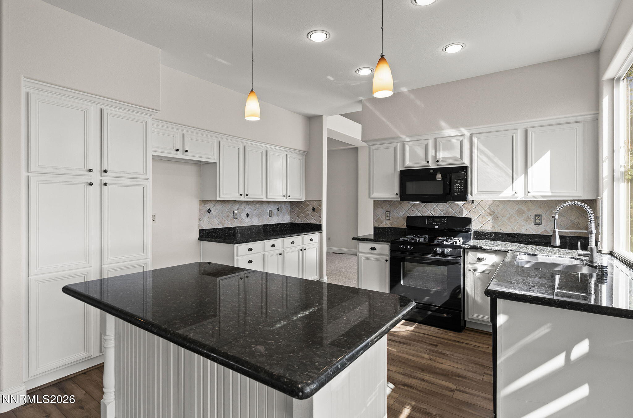 5490 Twin Creeks Drive Reno, NV 89523 - Photo 10 of 27 a kitchen with stainless steel appliances granite countertop a sink a stove top oven a counter space and cabinets