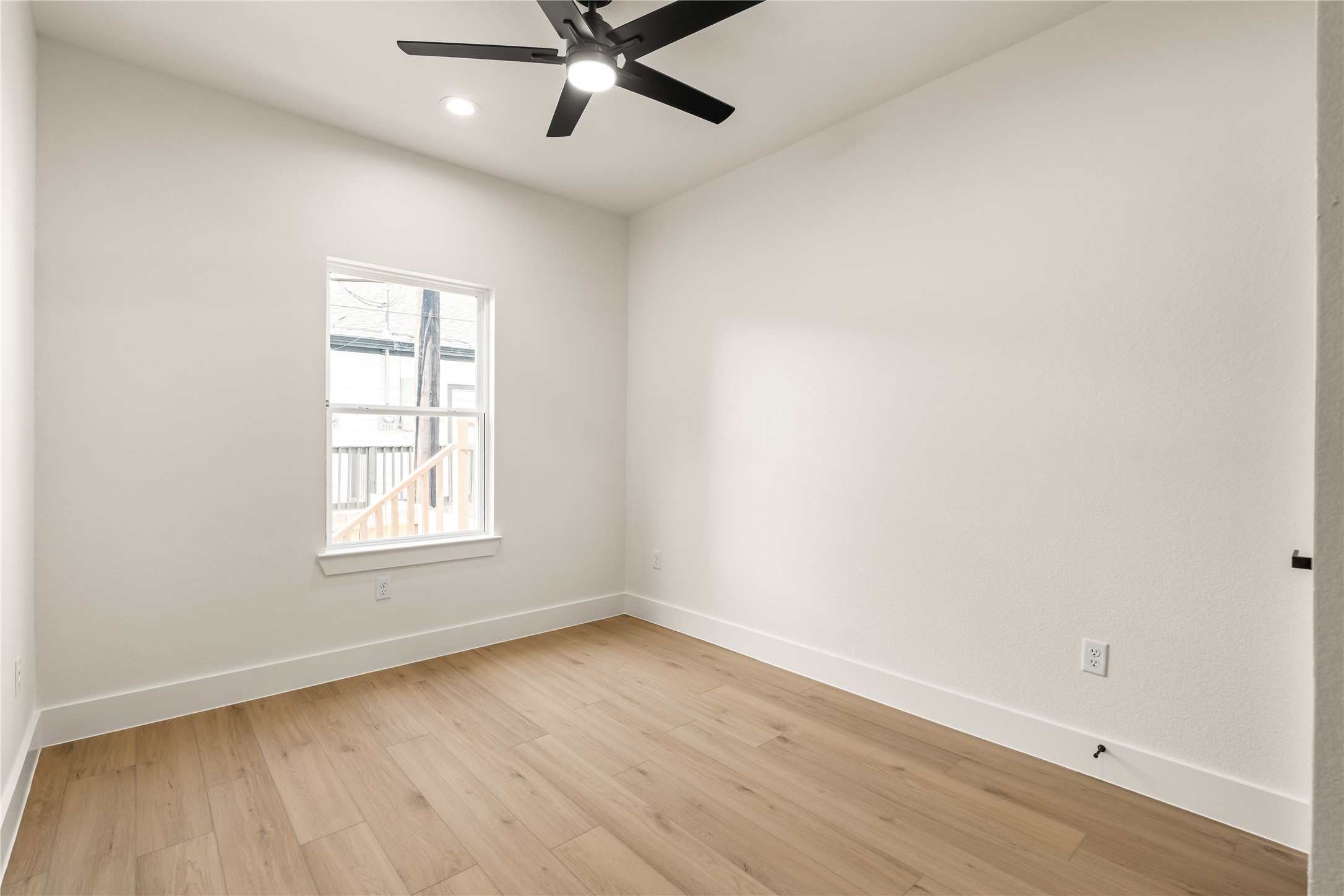 5321 Rue Street Houston, TX 77033 - Photo 19 of 23 Quiet corner bedroom — streams of natural light, matte black ceiling fan, and crisp modern trim package.