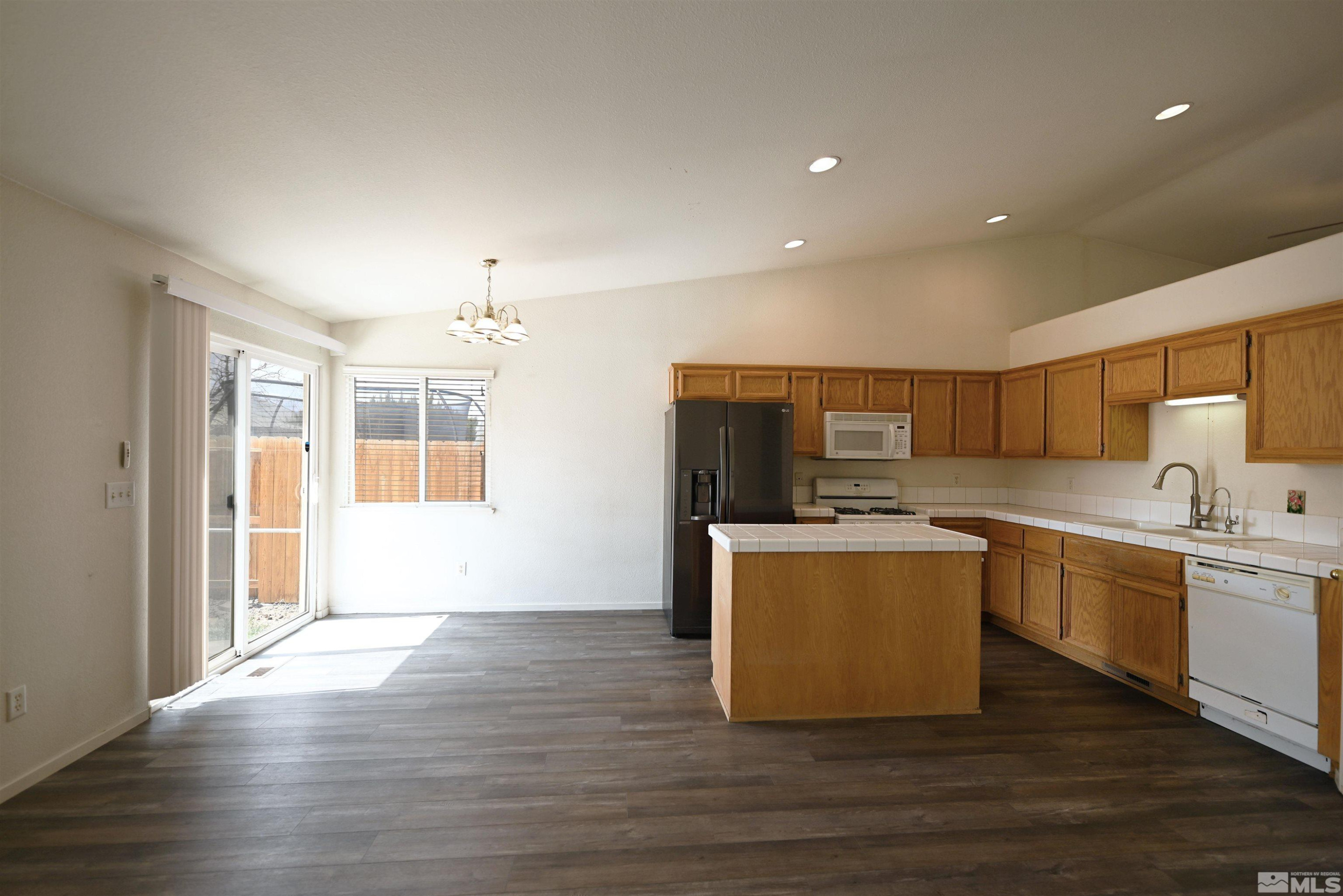 2129 Fort Bridger Road Fernley, NV 89408 - Photo 5 of 21 a living room with stainless steel appliances granite countertop a sink cabinets and wooden floor