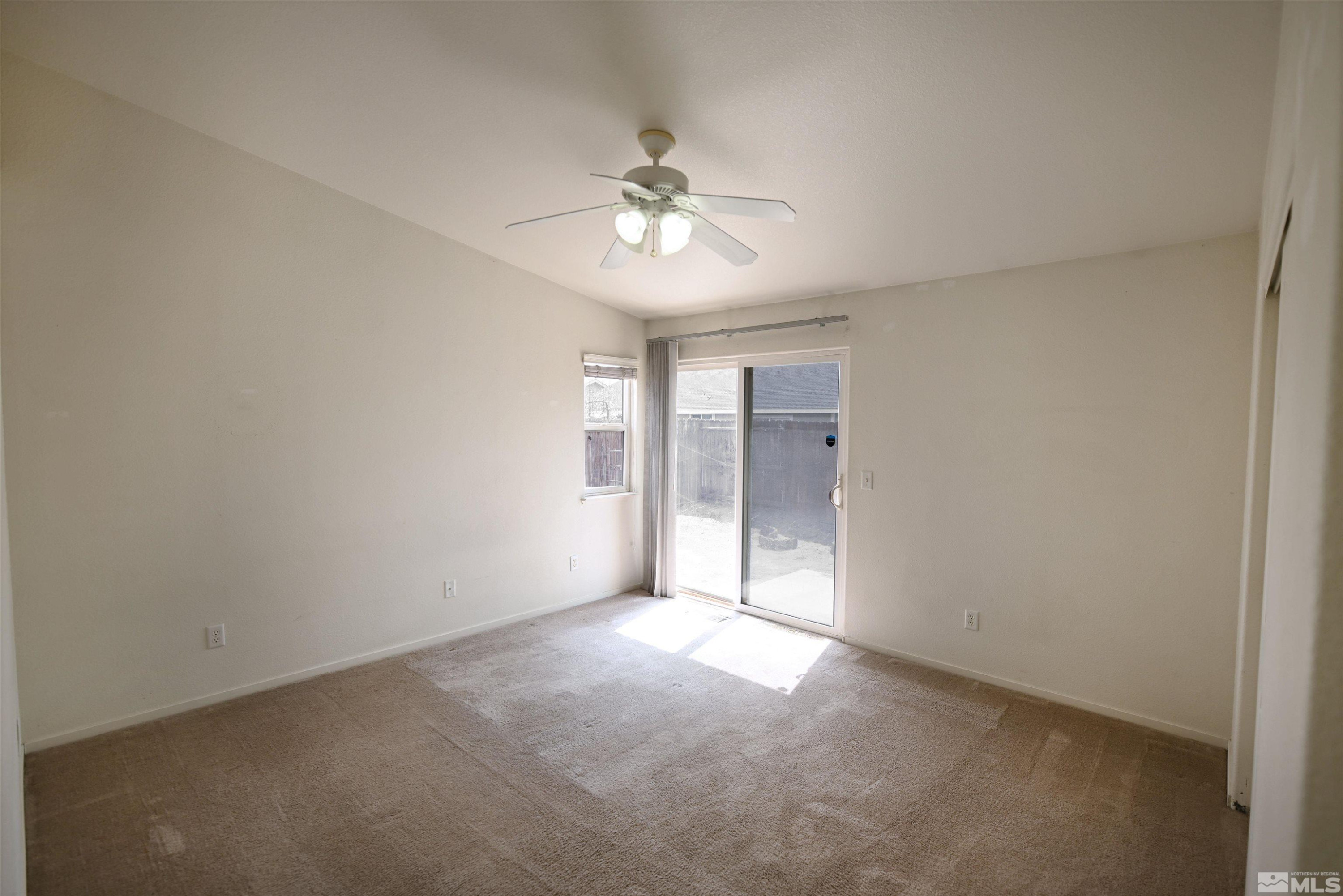 2129 Fort Bridger Road Fernley, NV 89408 - Photo 9 of 21 wooden floor in an empty room with a window
