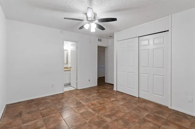 a view of an empty room with a ceiling fan
