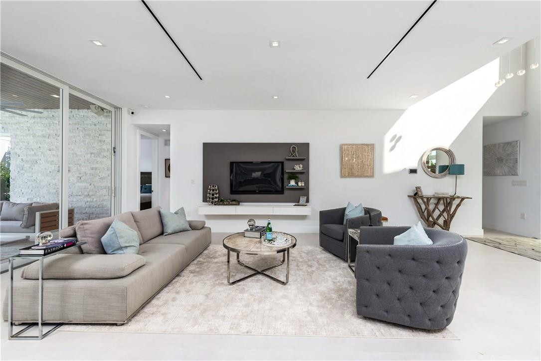 4610 Alton Road Miami Beach, FL 33140 - Photo 12 of 60 a living room with furniture and a flat screen tv