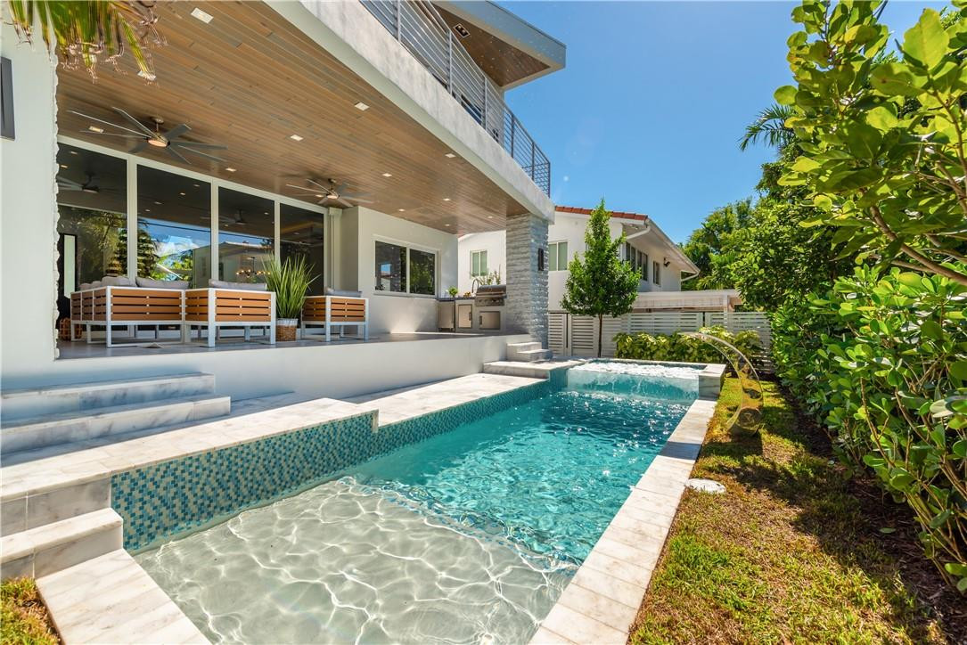 4610 Alton Road Miami Beach, FL 33140 - Photo 16 of 60 a swimming pool with outdoor seating and yard