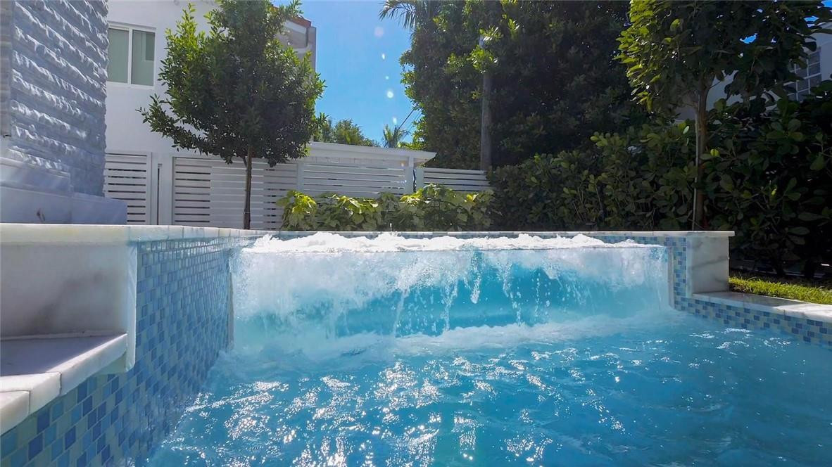 4610 Alton Road Miami Beach, FL 33140 - Photo 17 of 60 a backyard of a house with lots of green space