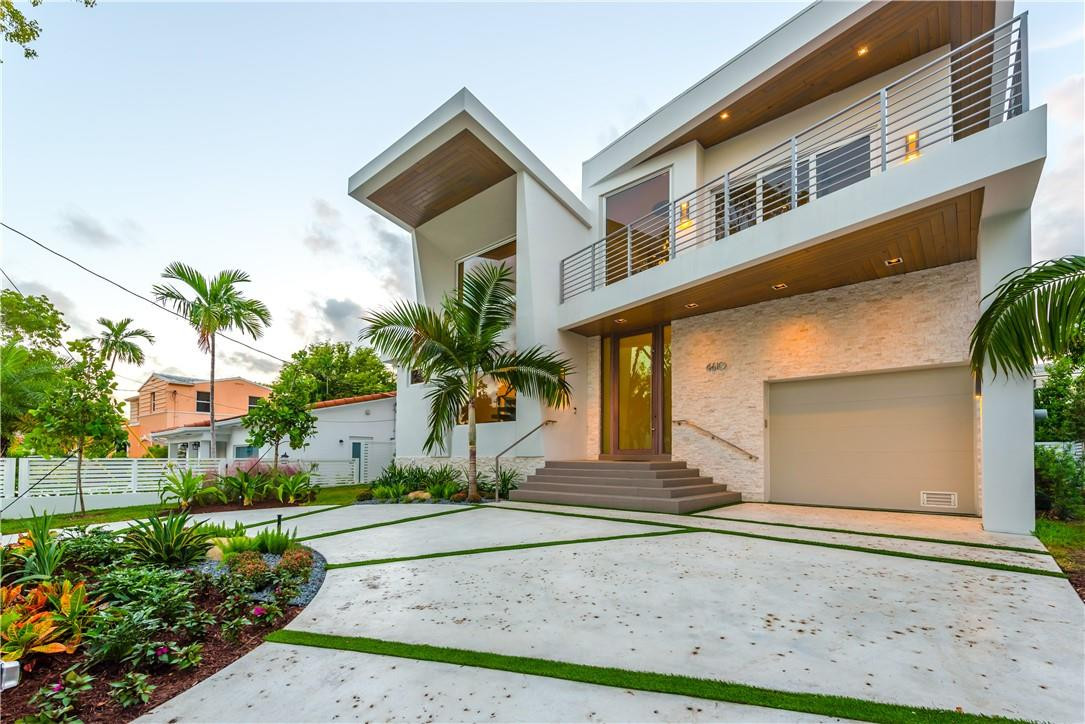 4610 Alton Road Miami Beach, FL 33140 - Photo 22 of 60 a front view of a house with a yard and a garage