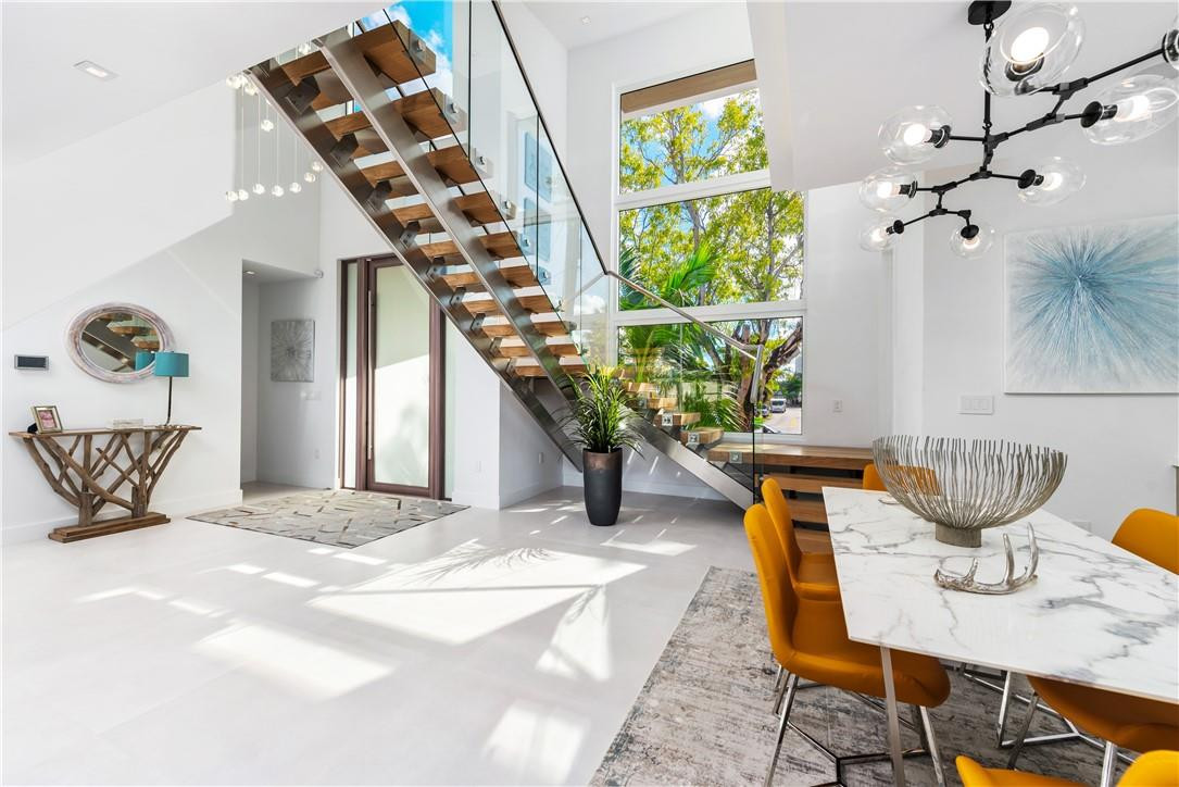 4610 Alton Road Miami Beach, FL 33140 - Photo 24 of 60 a view of a dining room with furniture a chandelier and wooden floor