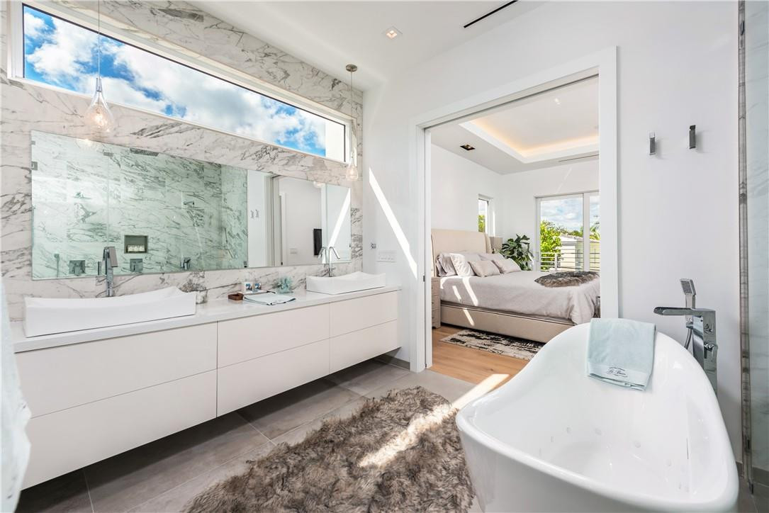 4610 Alton Road Miami Beach, FL 33140 - Photo 28 of 60 a living room with furniture and a large mirror