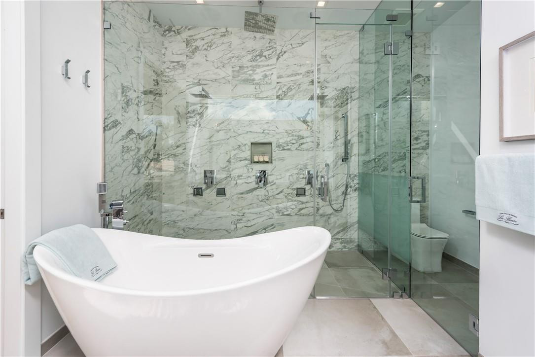 4610 Alton Road Miami Beach, FL 33140 - Photo 29 of 60 a white bath tub sitting next to a toilet