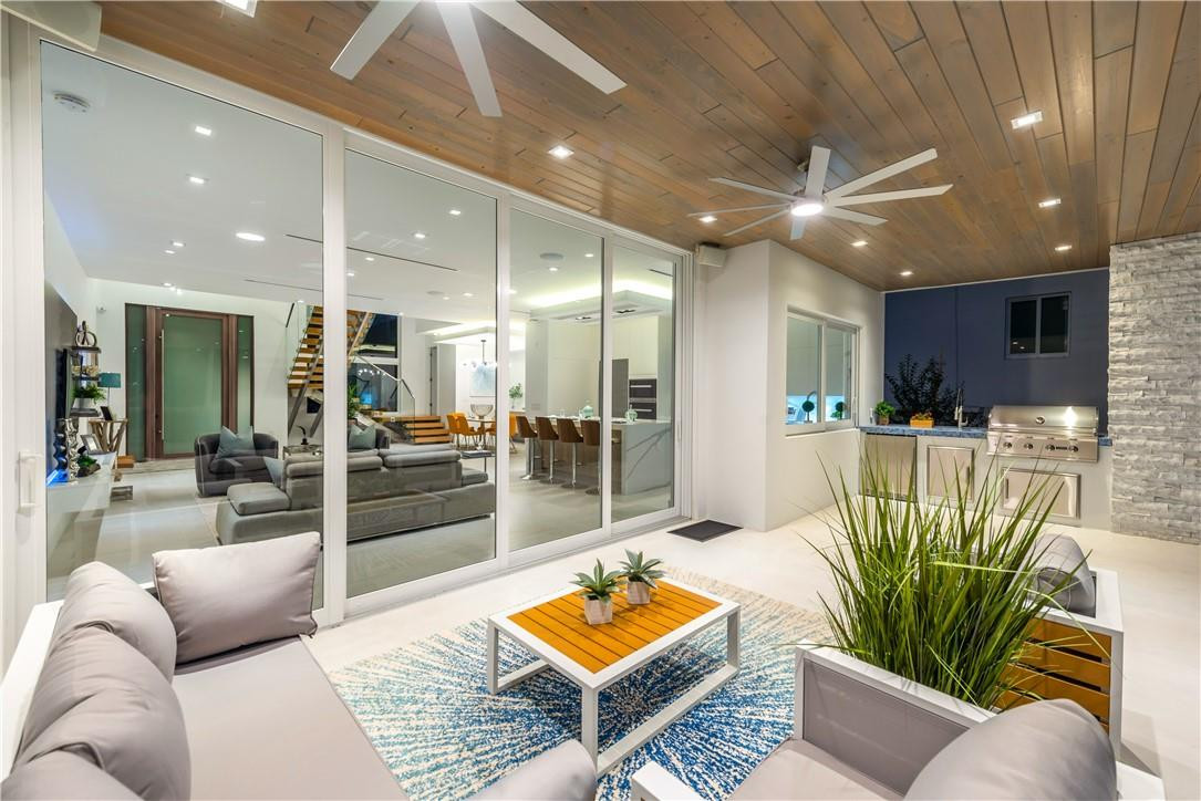 4610 Alton Road Miami Beach, FL 33140 - Photo 33 of 60 a living room with furniture a wooden floor and kitchen view