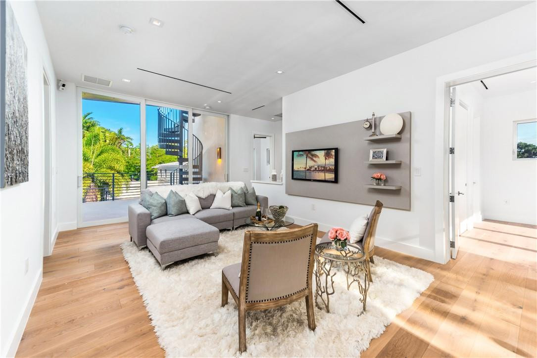 4610 Alton Road Miami Beach, FL 33140 - Photo 41 of 60 a living room with furniture and a large window