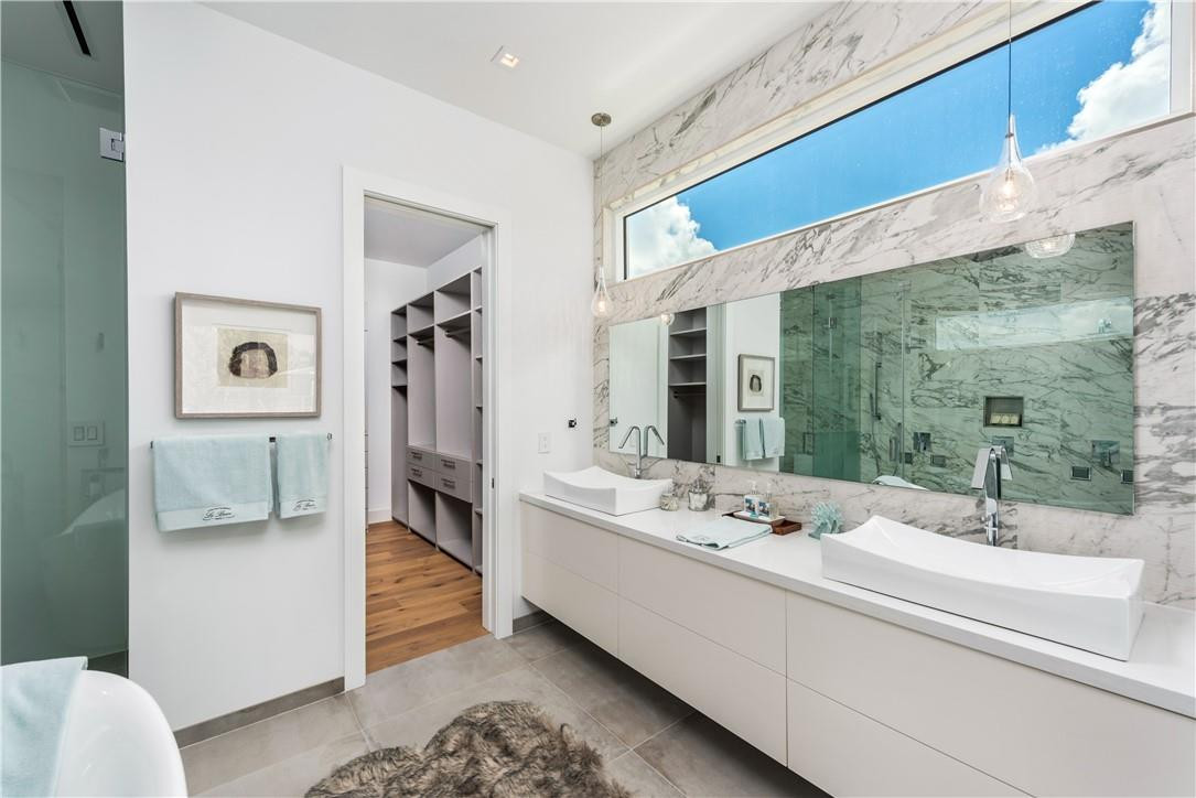 4610 Alton Road Miami Beach, FL 33140 - Photo 43 of 60 a bathroom with a double vanity sink mirror and toilet