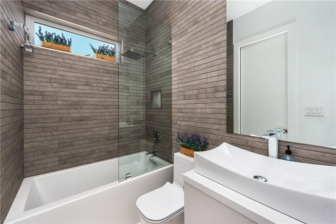 4610 Alton Road Miami Beach, FL 33140 - Photo 44 of 60 a bathroom with a sink a toilet and bathtub