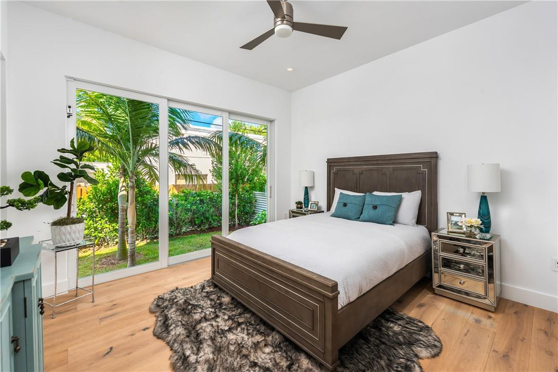 4610 Alton Road Miami Beach, FL 33140 - Photo 45 of 60 a bed sitting in a bedroom next to a window