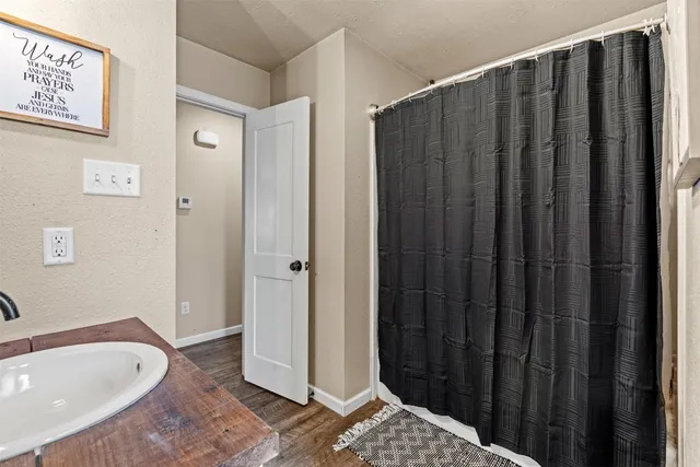 a bathroom with shower a bathtub and a sink