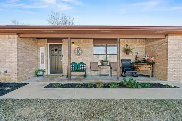 a front view of a house with porch and outdoor seating