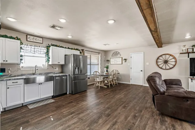 a large white kitchen with a large window