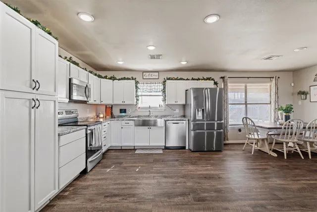 a kitchen with refrigerator and cabinets