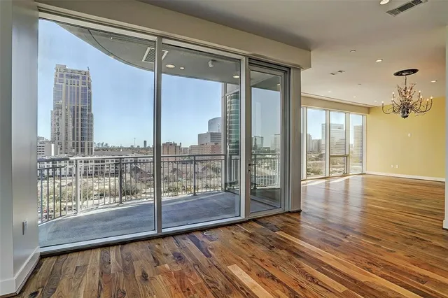 a view of a room with wooden floor and city view