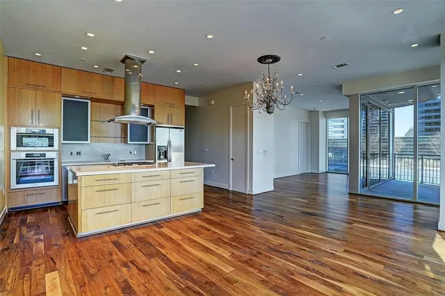 a kitchen with stainless steel appliances kitchen island granite countertop a sink and cabinets