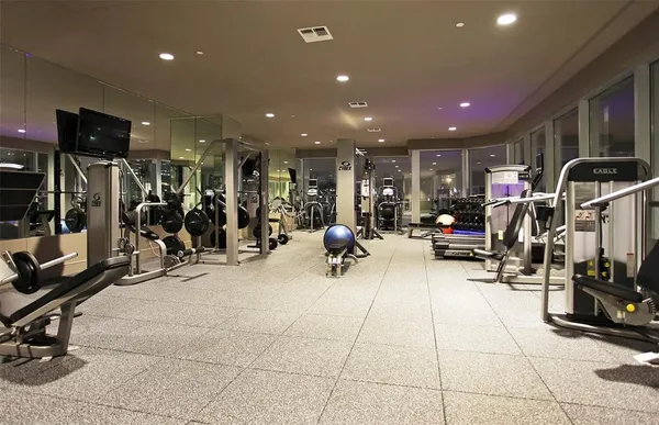 a kitchen that has a lot of cabinets and wooden floor