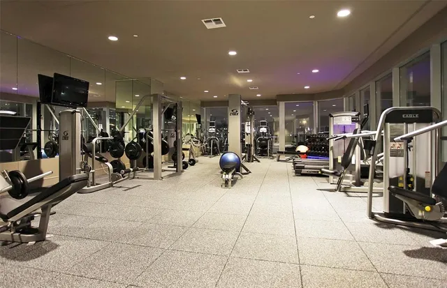 a kitchen that has a lot of cabinets and wooden floor