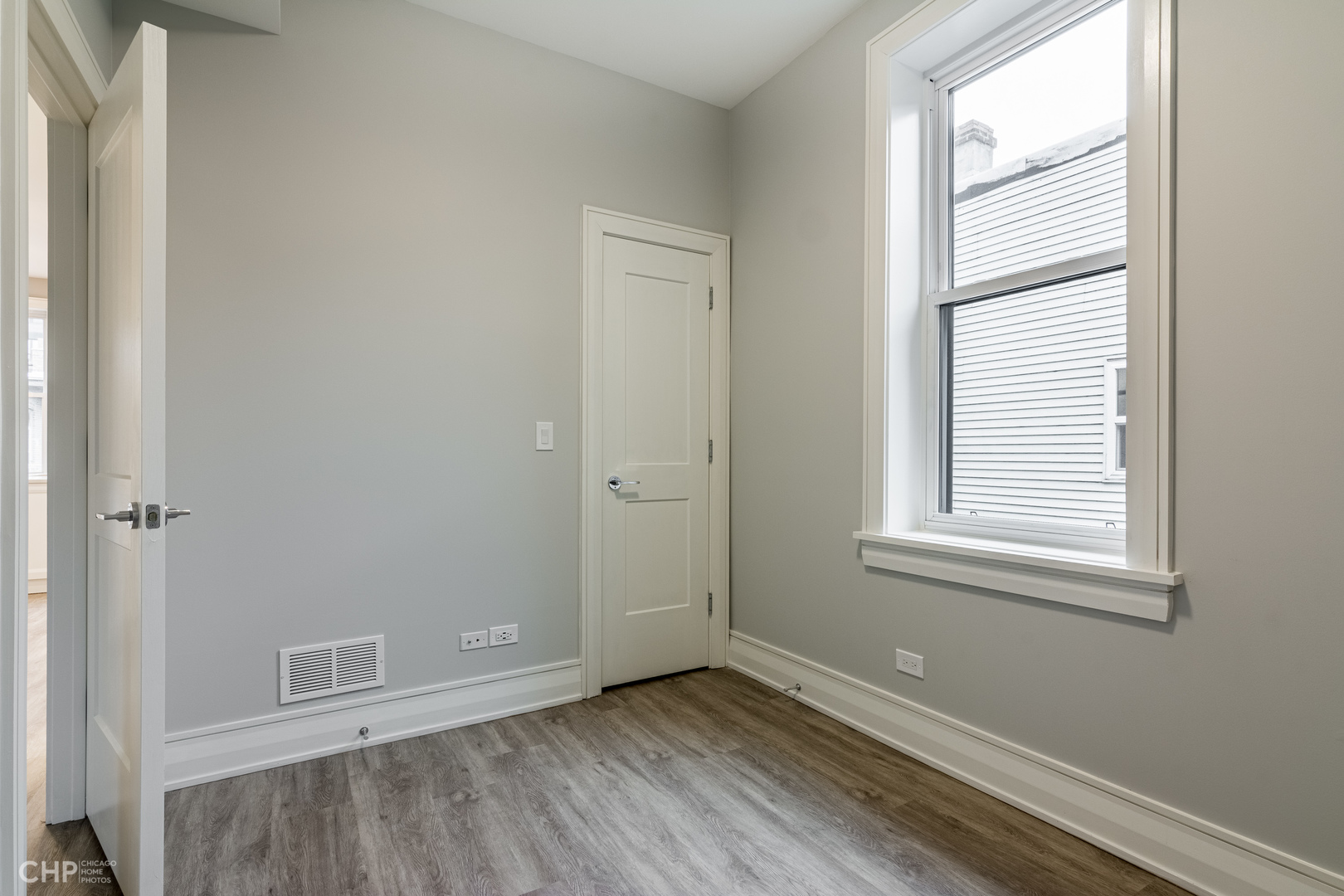 2318 West Thomas Street, Unit 3R Chicago, IL 60622 - Photo 6 of 12 a view of an empty room with wooden floor and a window