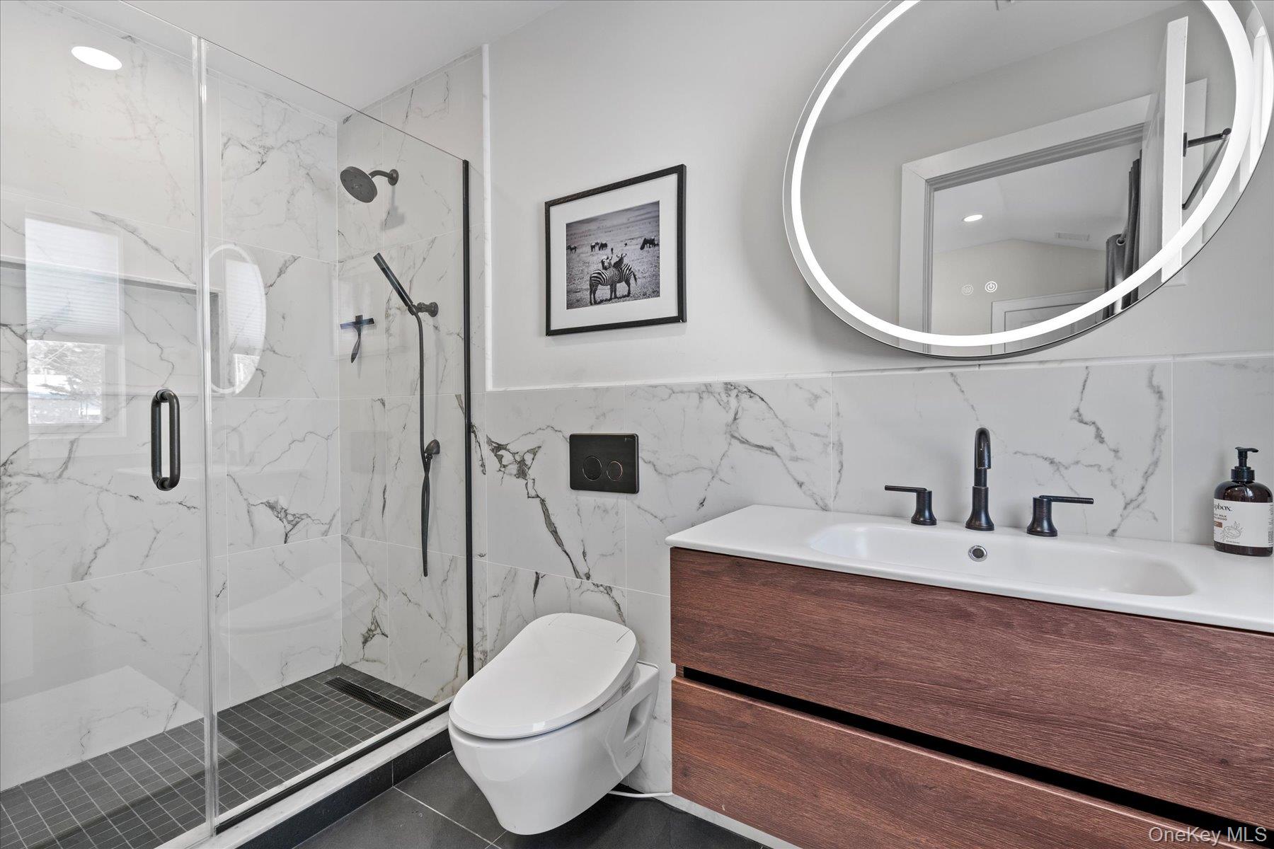 1150 Ruth Road Mattituck, NY 11952 - Photo 11 of 19 a bathroom with a sink a toilet and a mirror