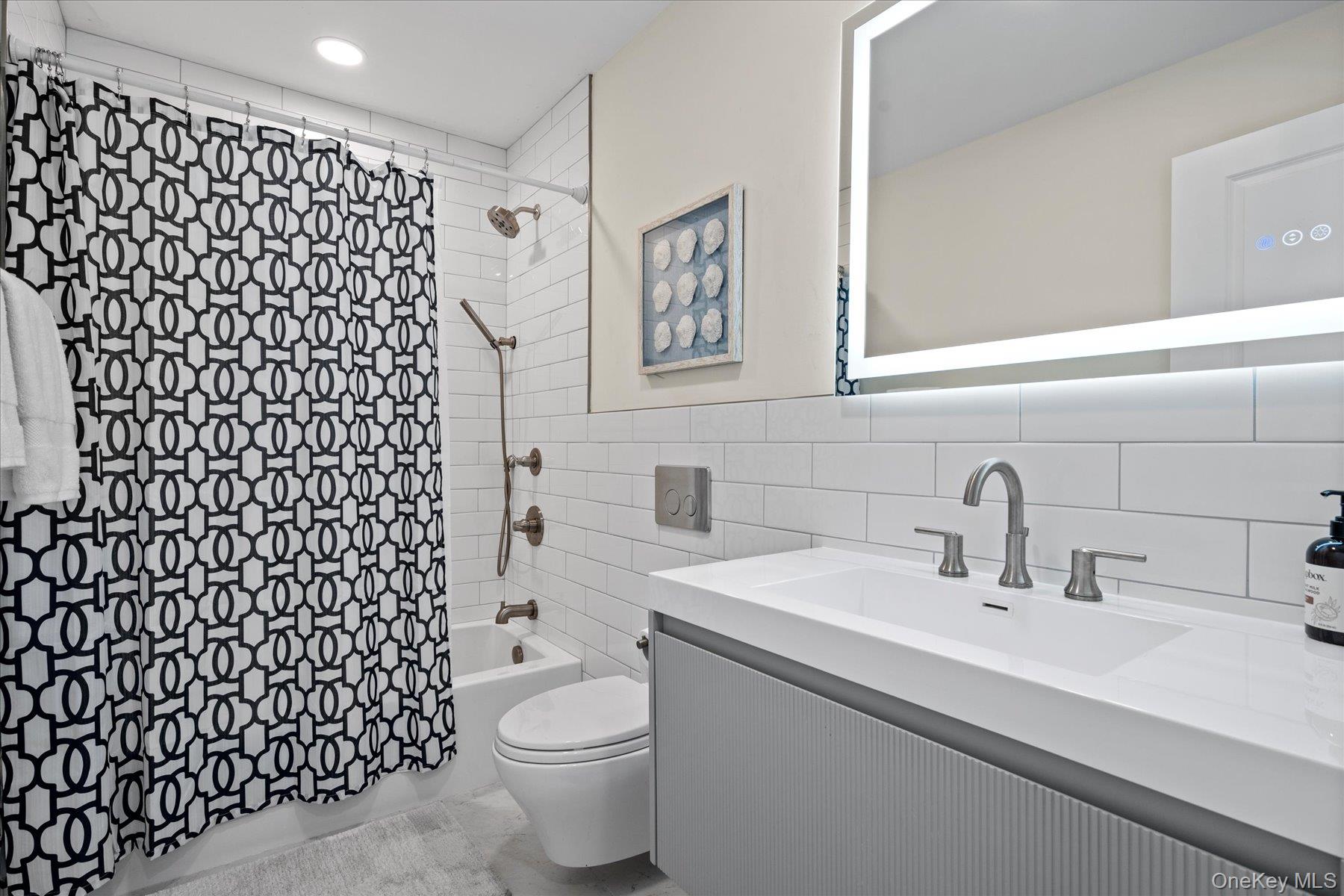 1150 Ruth Road Mattituck, NY 11952 - Photo 13 of 19 a bathroom with a sink a toilet and a shower