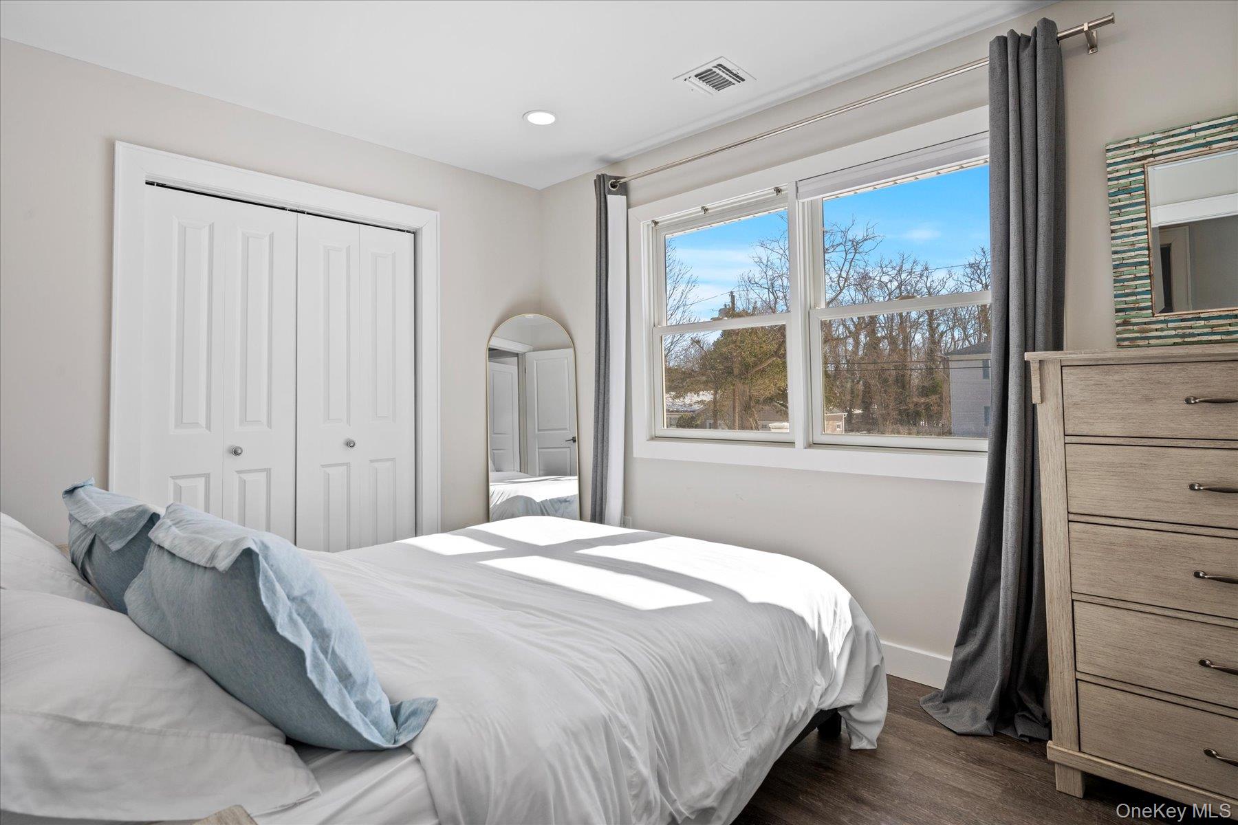 1150 Ruth Road Mattituck, NY 11952 - Photo 14 of 19 a bedroom with a large bed and a window