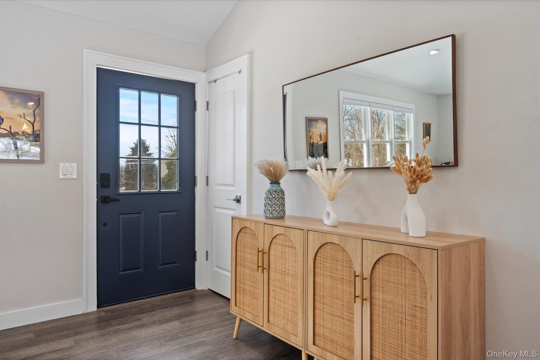 1150 Ruth Road Mattituck, NY 11952 - Photo 2 of 19 a view of a bedroom with wooden floor and windows