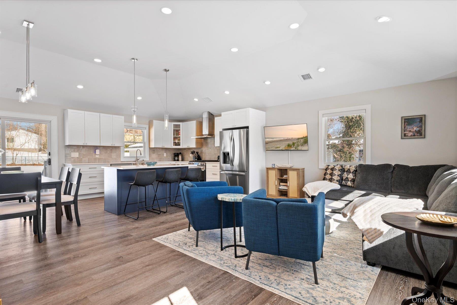1150 Ruth Road Mattituck, NY 11952 - Photo 3 of 19 a living room with stainless steel appliances kitchen island granite countertop wooden floor a dining table and chairs