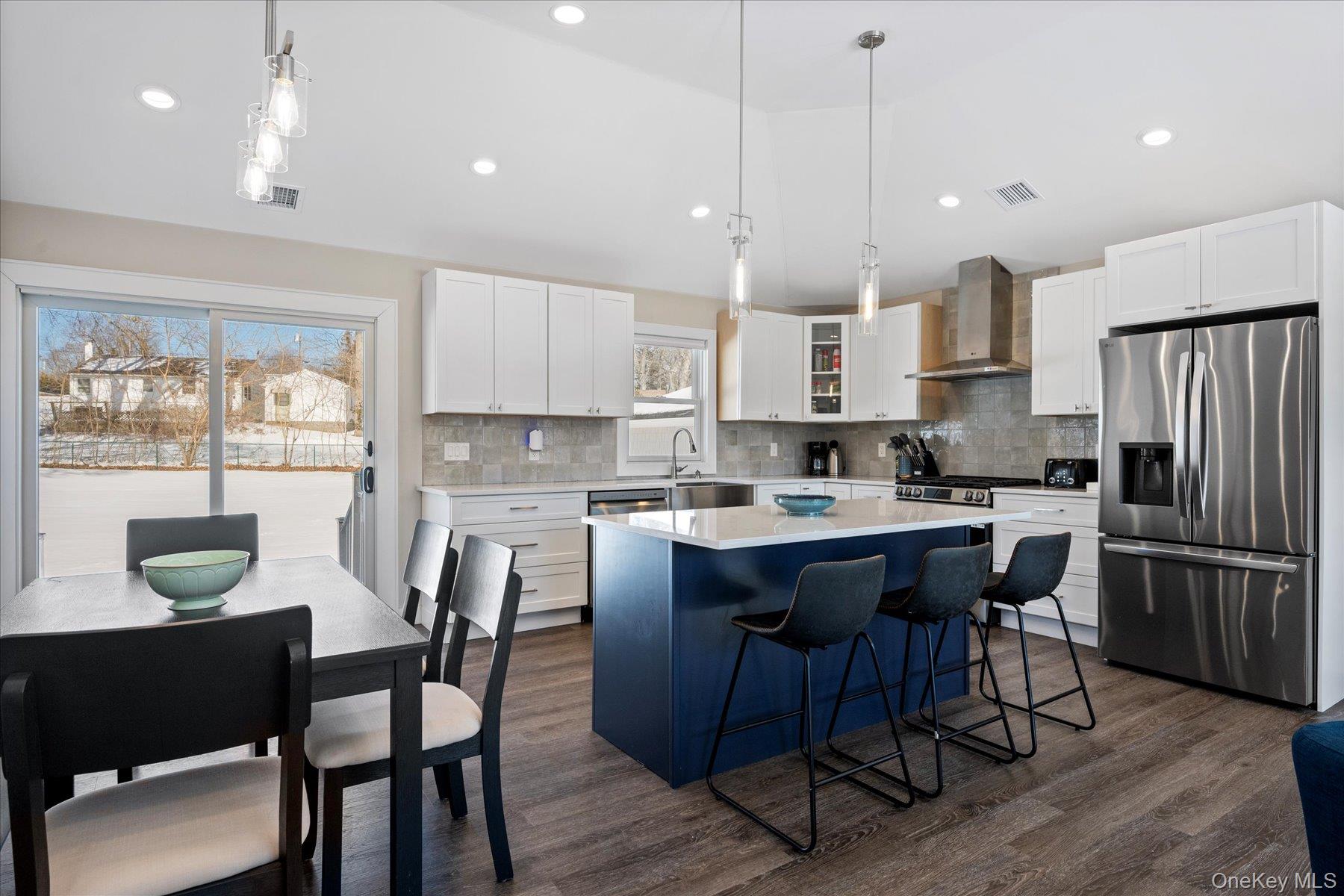 1150 Ruth Road Mattituck, NY 11952 - Photo 6 of 19 a kitchen with kitchen island a dining table and chairs